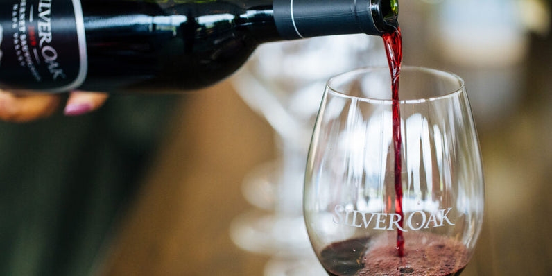 Is Wine Gluten Free Blog Post. Bottle of Silver Oak Napa Valley Cabernet Sauvignon being poured into a wine glass.