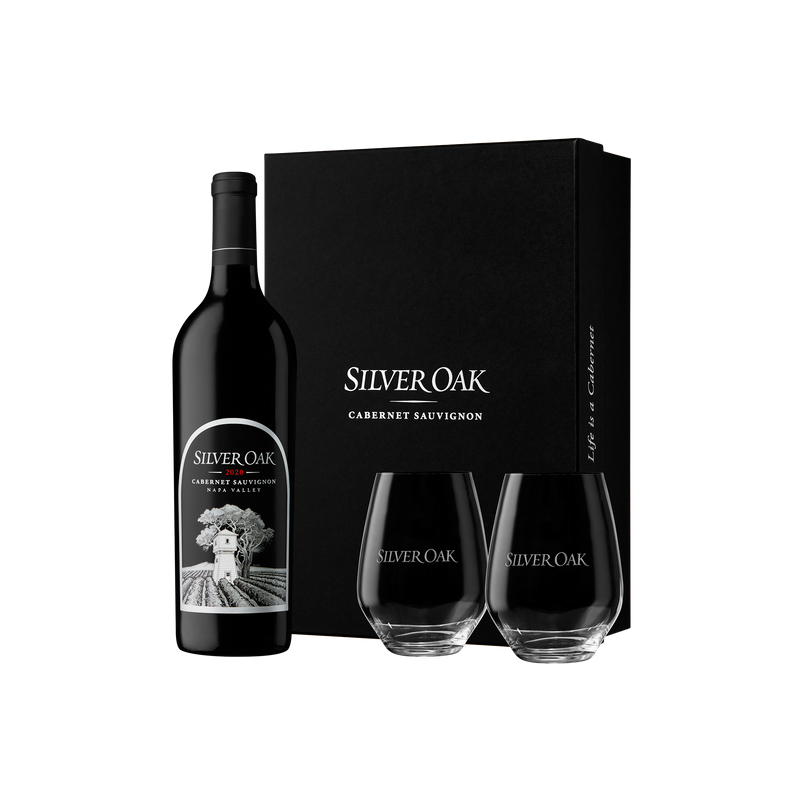 Silver Oak Napa Valley Cabernet Sauvignon wine bottle and two stemless wine glasses with a sleek black box on a white background