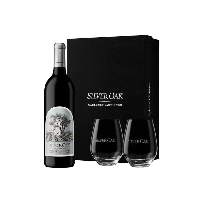 Silver Oak 2022 Alexander Valley Cabernet Sauvignon wine bottle with two stemless wine glasses glasses and a black gift box