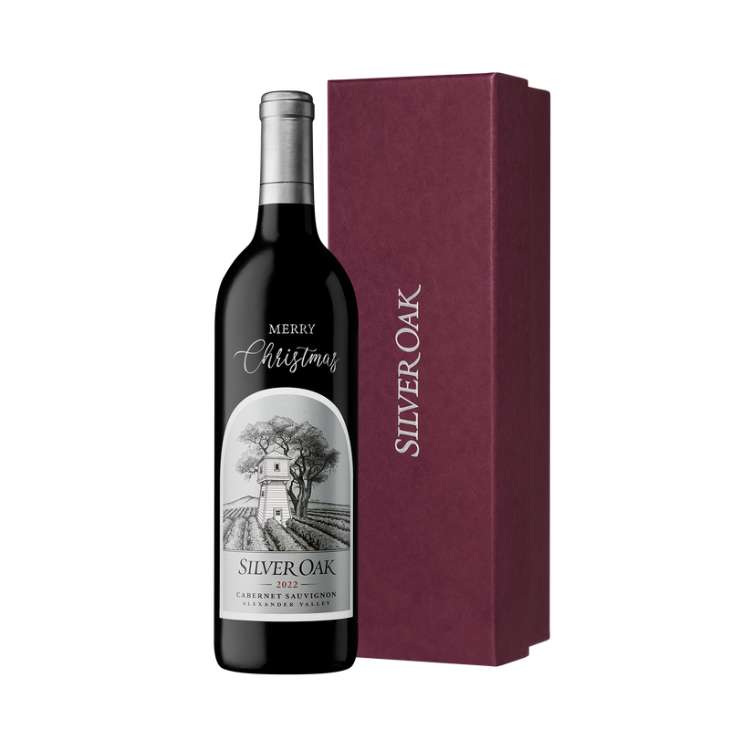 Silver Oak 2022 Alexander Valley Cabernet Sauvignon engraved and hand painted with Merry Christmas, beside a burgundy box